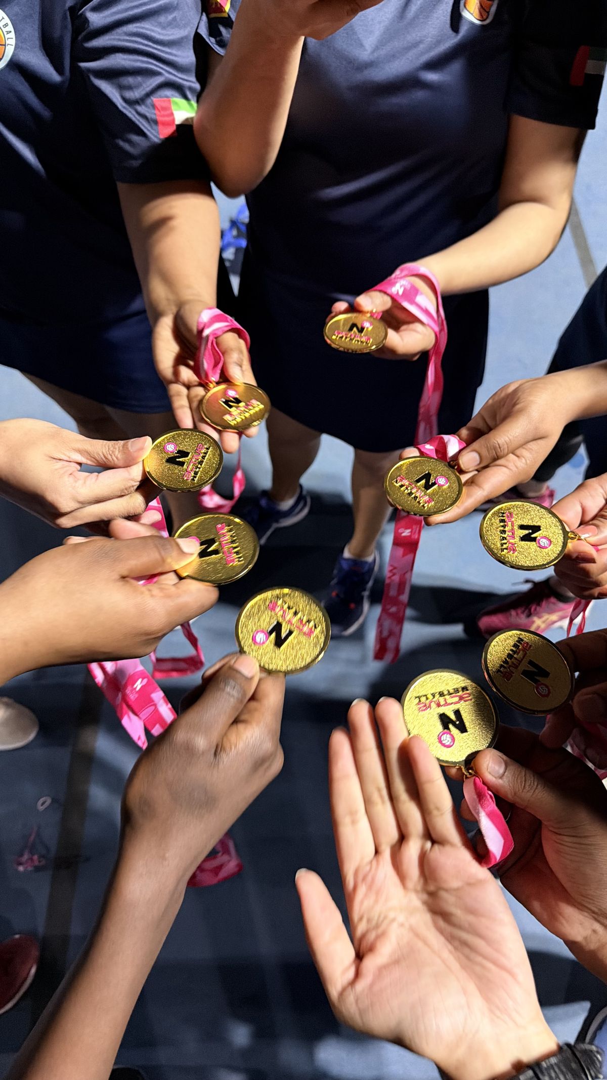 Sparks Netball players celebrating with medals at the Active Sports Spring League